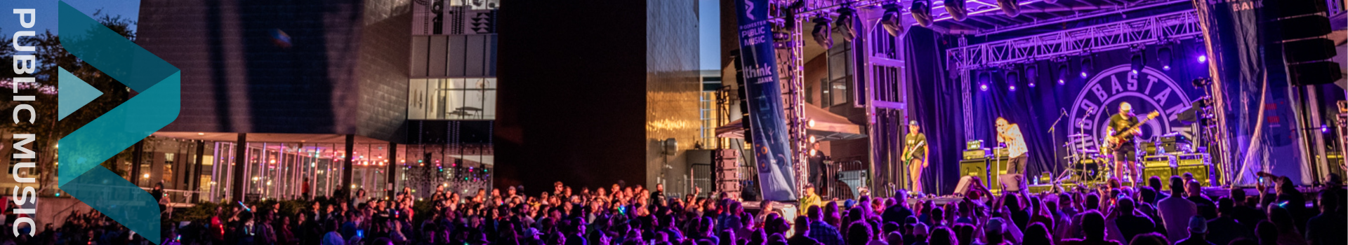 outdoor concert venue in the evening with large crowd